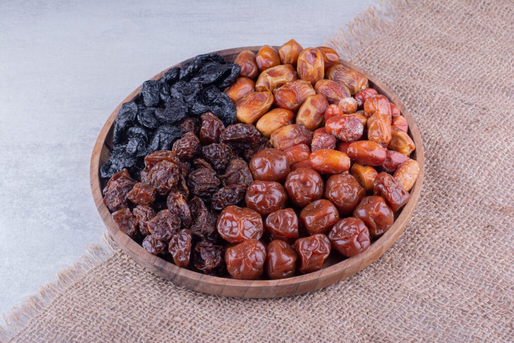 Different types of Dates stored in wooden bowl