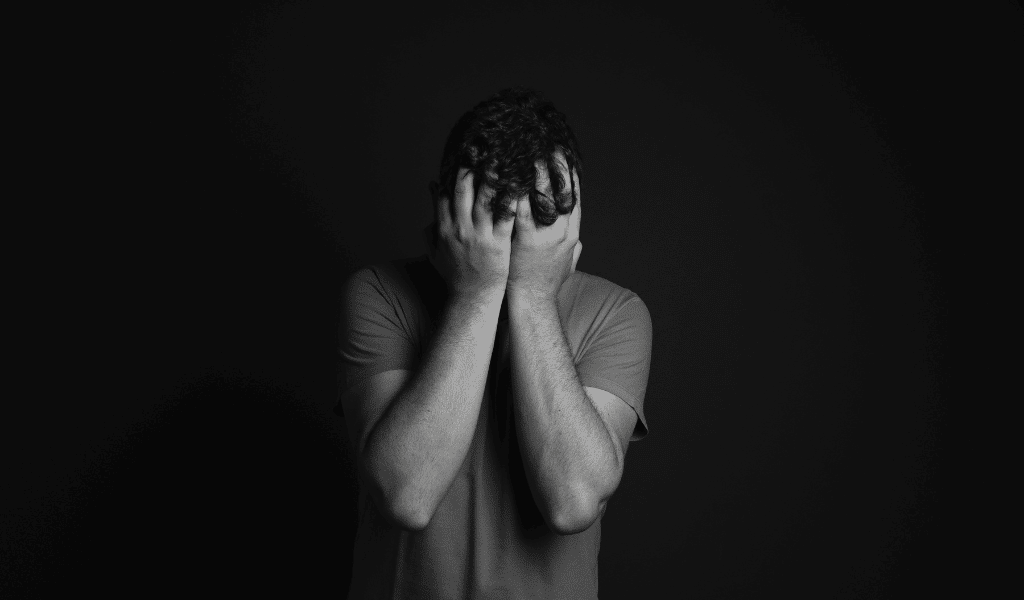 man pain as a headache behind black background