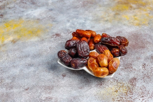 Ajwa & Medjoul dates are plate with gradient background