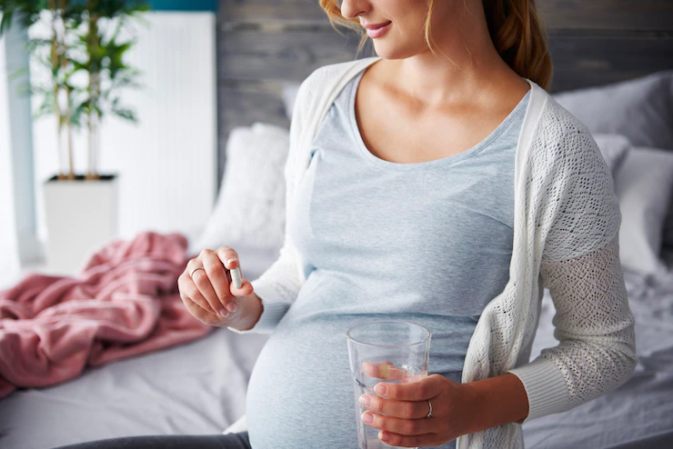 young pregnant women take a capsules