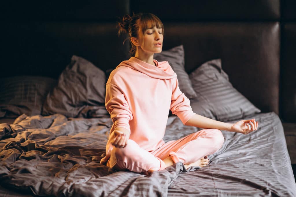 young girl to yoga on bed before sleeping